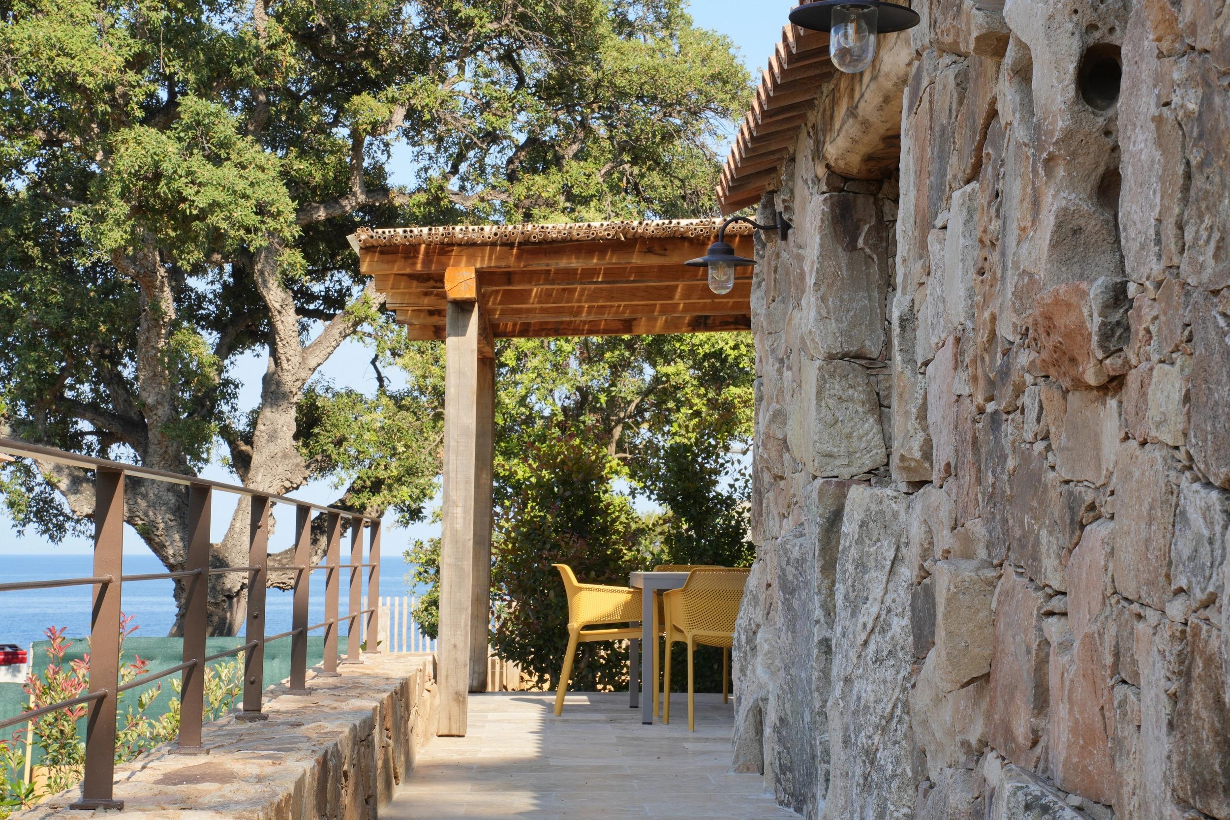 Terrasse en bois et façade en pierre des hébergements Vista Blu entre Fautea et Tarco